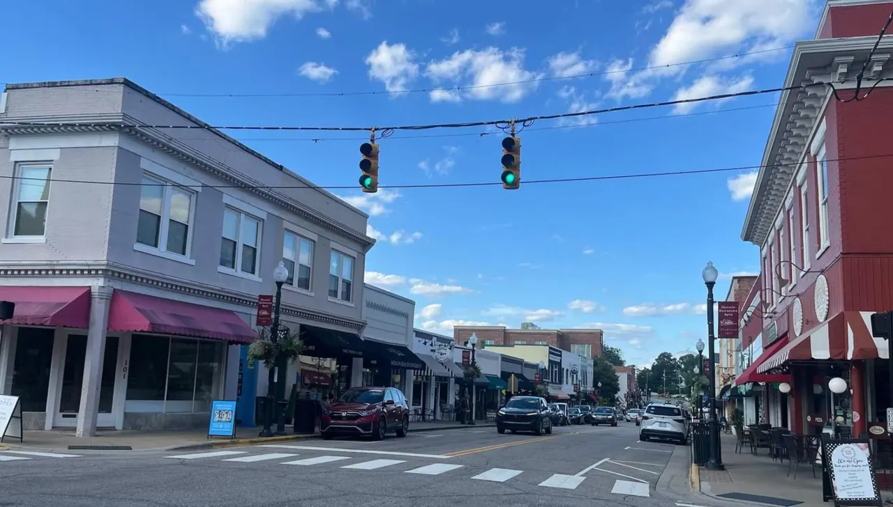 Downtown Apex, North Carolina, looking along the main street of shopfronts under a blue sky