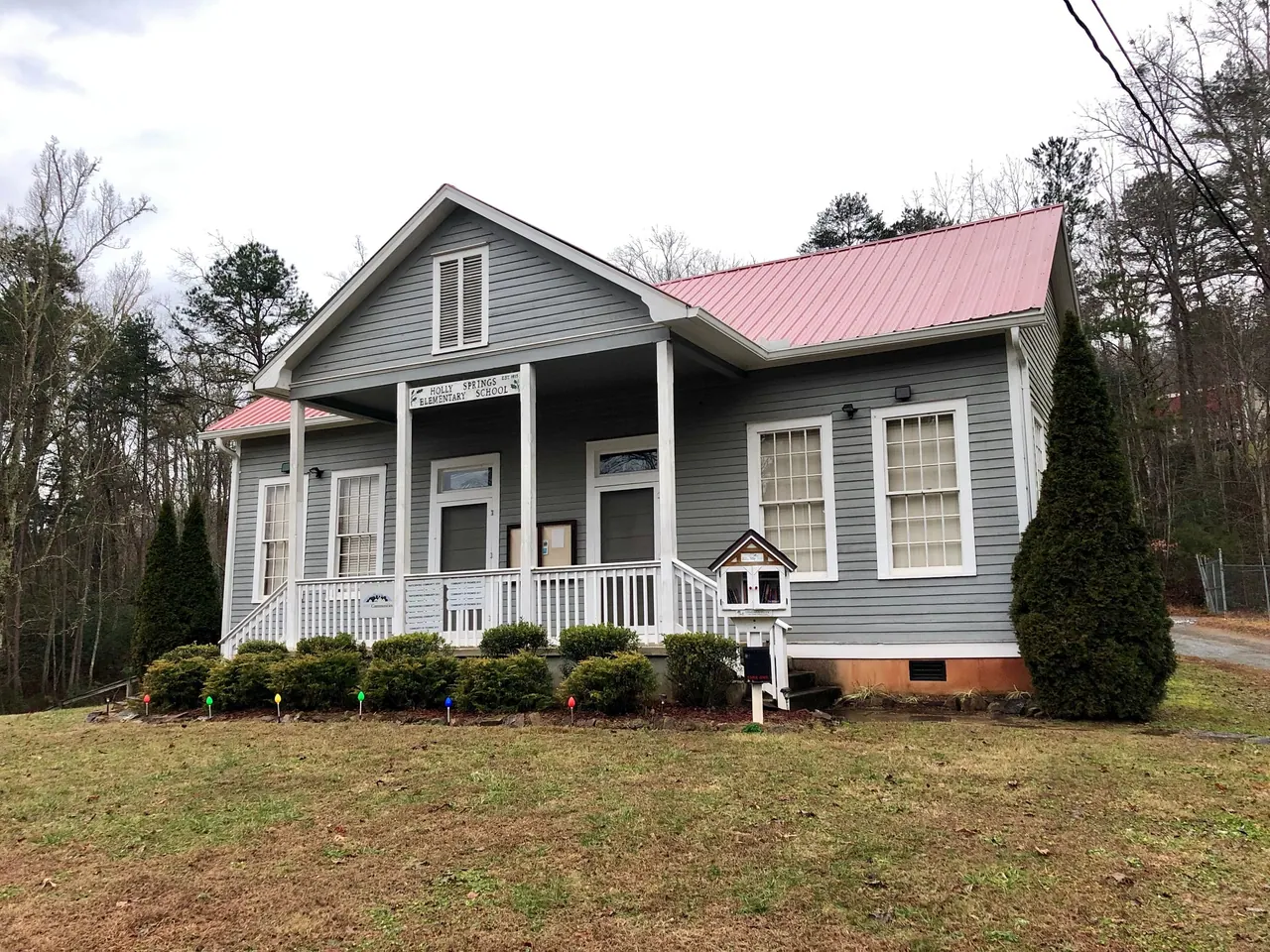 The historic Old Holly Springs School building on a clear day in Holly Springs, North Carolina