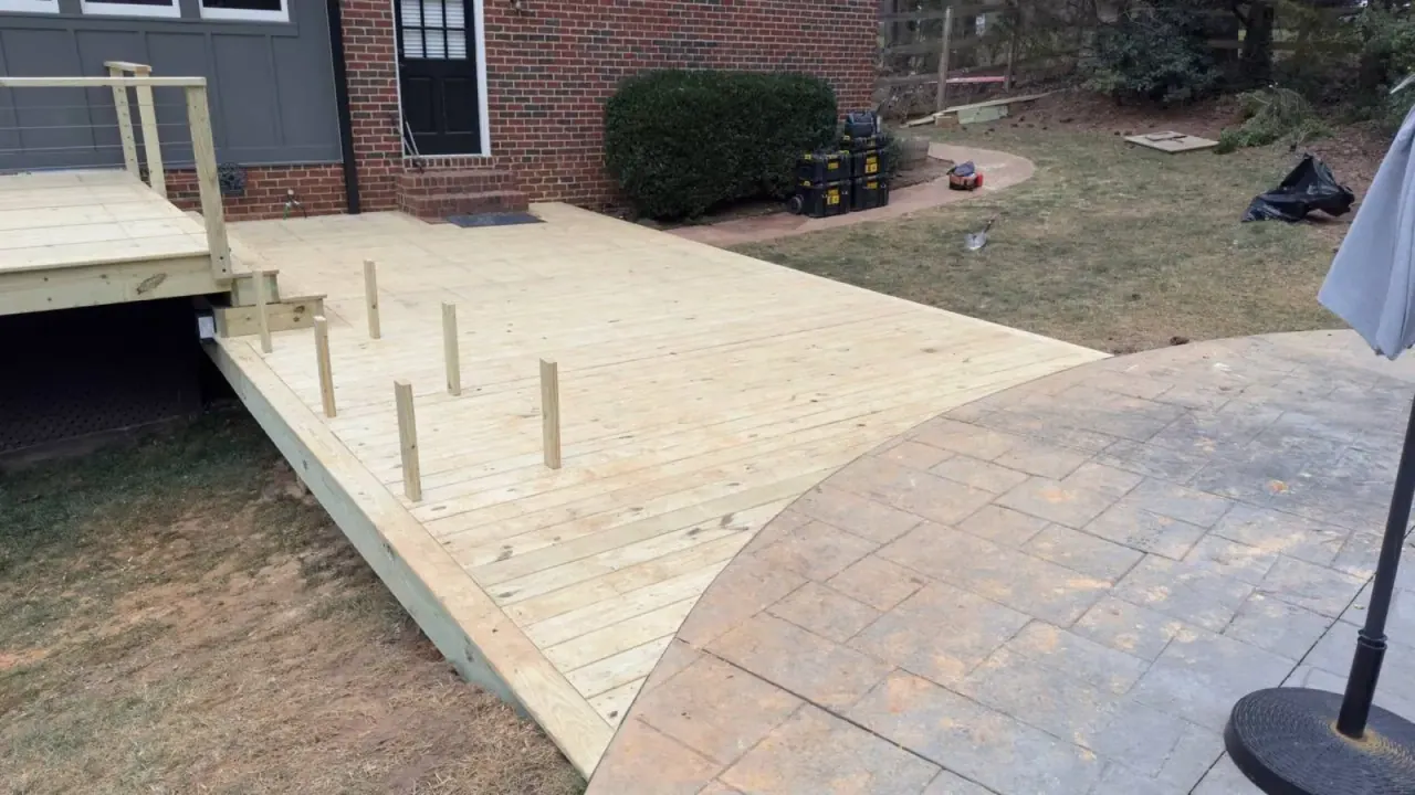 Deck landing meeting a curved paver patio at grade